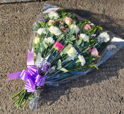 Cello Sheaf - Elegant pastel cello sheaf with pink roses, white blooms and seasonal flowers. Handcrafted by Four Seasons Florist for a heartfelt sympathy tribute.