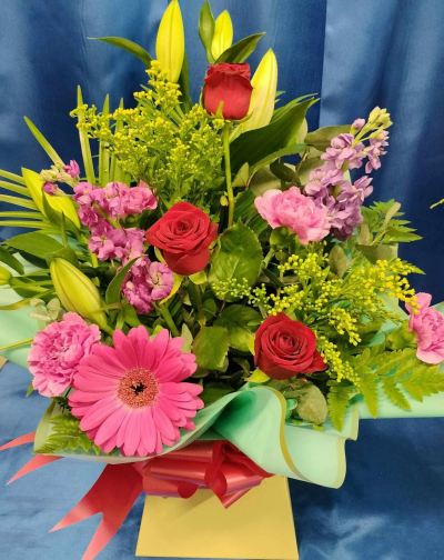 Vibrant Box Bouquet - Bright gift box with red roses, pink gerbera, lilies and carnations. Handcrafted by Four Seasons Florist for birthdays and vibrant celebrations.